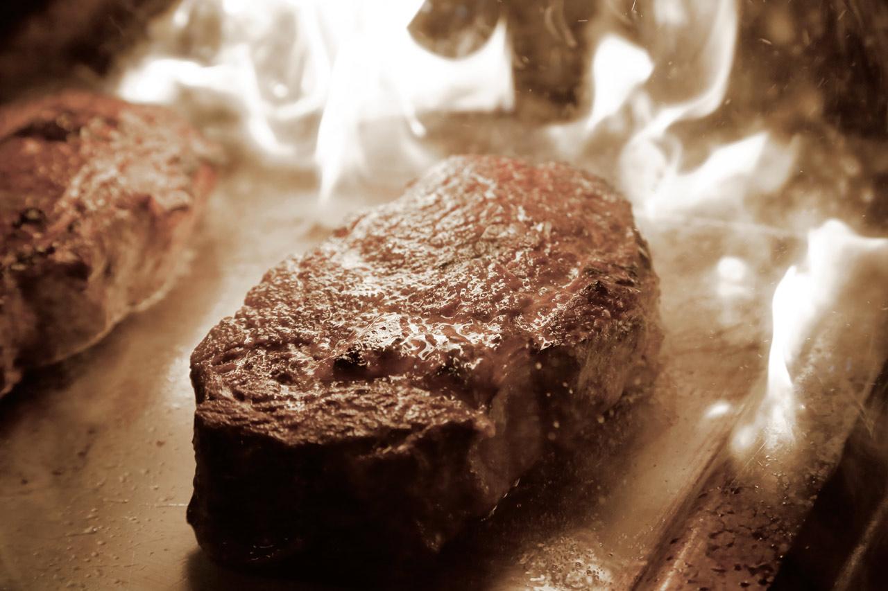 GRAND ELYSEE Hamburg Bagian luar foto A steak being cooked